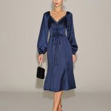 Jūrinės satino V formos raukšlėta midi suknelė" can be rewritten as "V-Neck Pleated Midi Dress in Marine Satin.
